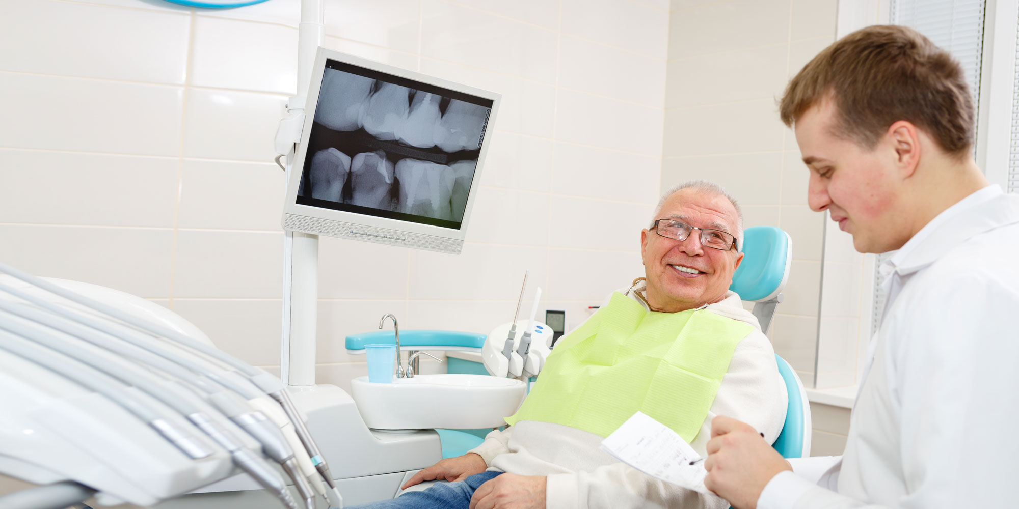 dentist discussing implant options olderman